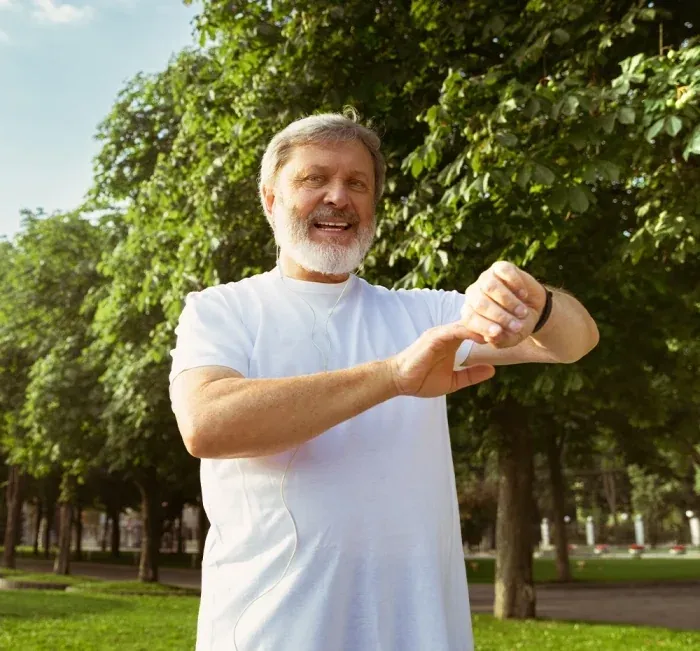 Man in a park checking his watch