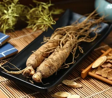 Two ginseng roots on a black tray